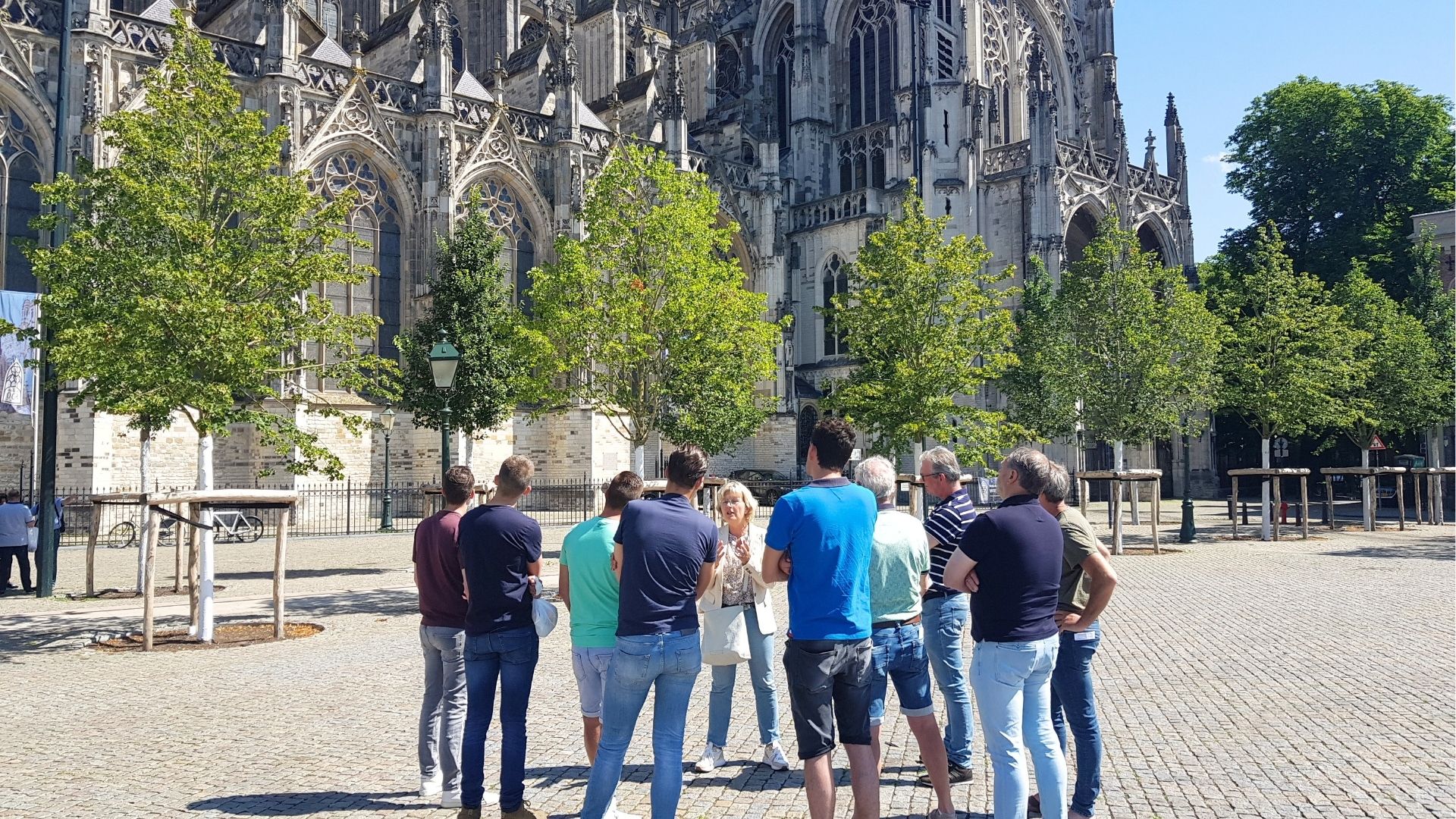 Stadsgids Margot van Ham met een groep op de Parade tijdens een stadswandeling in 's-Hertogenbosch.